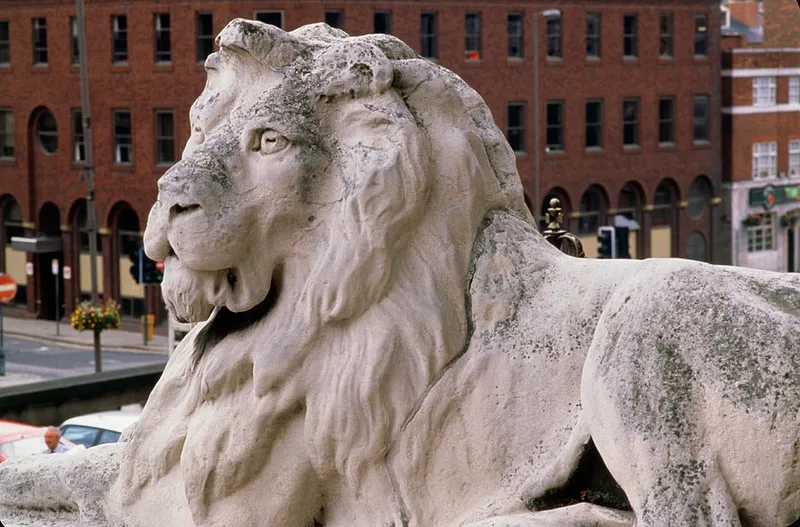 Photo of a stone lion disfigured by acid rain